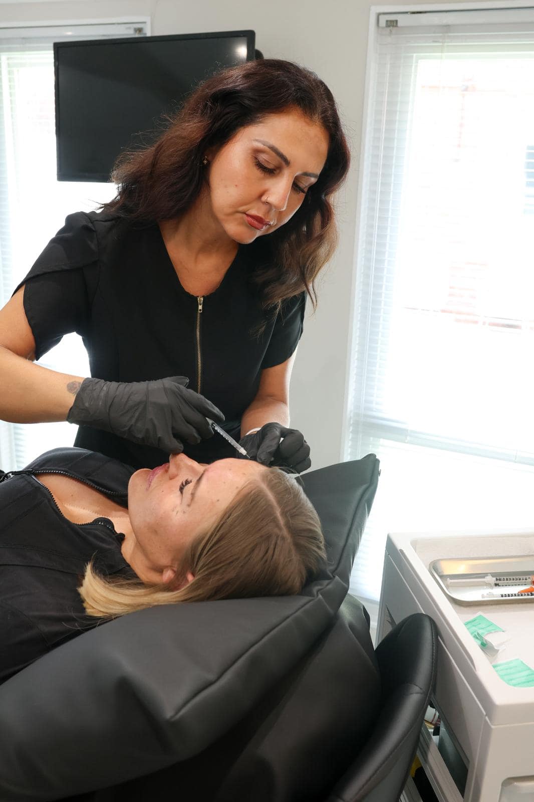 Safina Young carrying out an injectable treatment on a client in her Bracknell studio